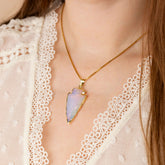 Model wearing raw opalite crystal pendant - gold plated edging - gold box chain
